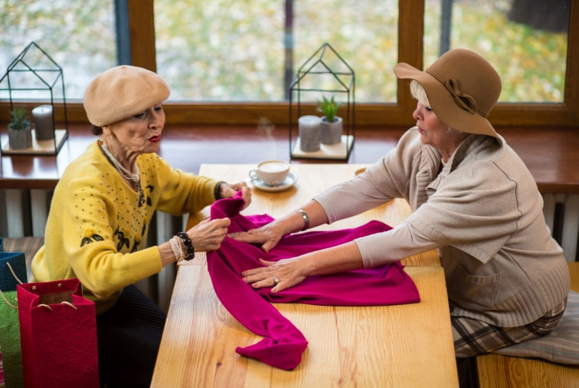 Two senior women with clothes.