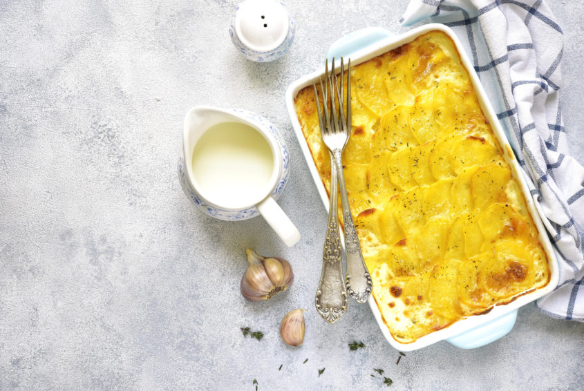 Potato gratin in a blue bakibg dish.Vintage style,top view.