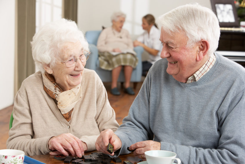 Couple Playing Dominoes At Day Care Centre