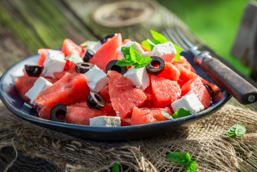 Watermelon salad with black olives and feta cheese in garden Arbuz i ser feta - sałatka