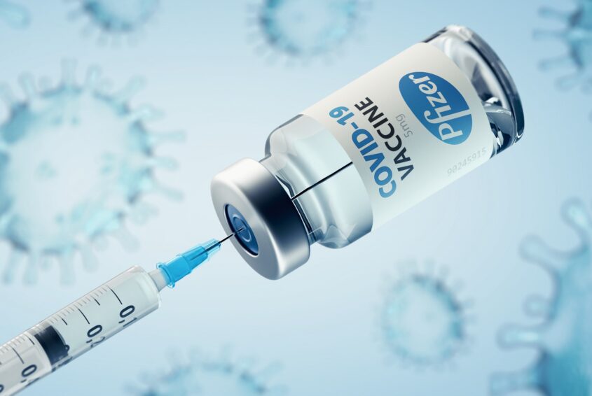 Covid-19 Pfizer Vaccine and injection syringe. Szczepienia przeciw COVID-19