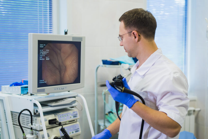 proctologist doctor holding Ligador hemorroidal in office kolonoskopia bez skierowania